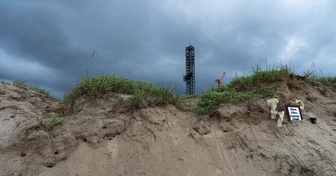 A SpaceX platform behind a dune at Boca Chica beach on Aug. 8, 2024.
