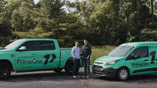Two young men stand outside next to service vans with a logo for Prime-One, the Internet provider they founded. Two young men stand outside next to service vans with a logo for Prime-One, the Internet provider they founded.