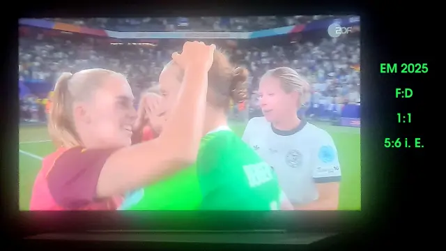 Fernseher zeigt eine Umarmung nach dem Fußballspiel, Ann-Katrin Berger wird gefeiert