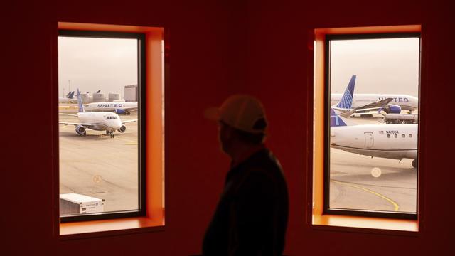 A traveler passes United Airlines planes at San Francisco International Airport on May 8, 2025, in San Francisco. (AP Photo/Noah Berger, File)